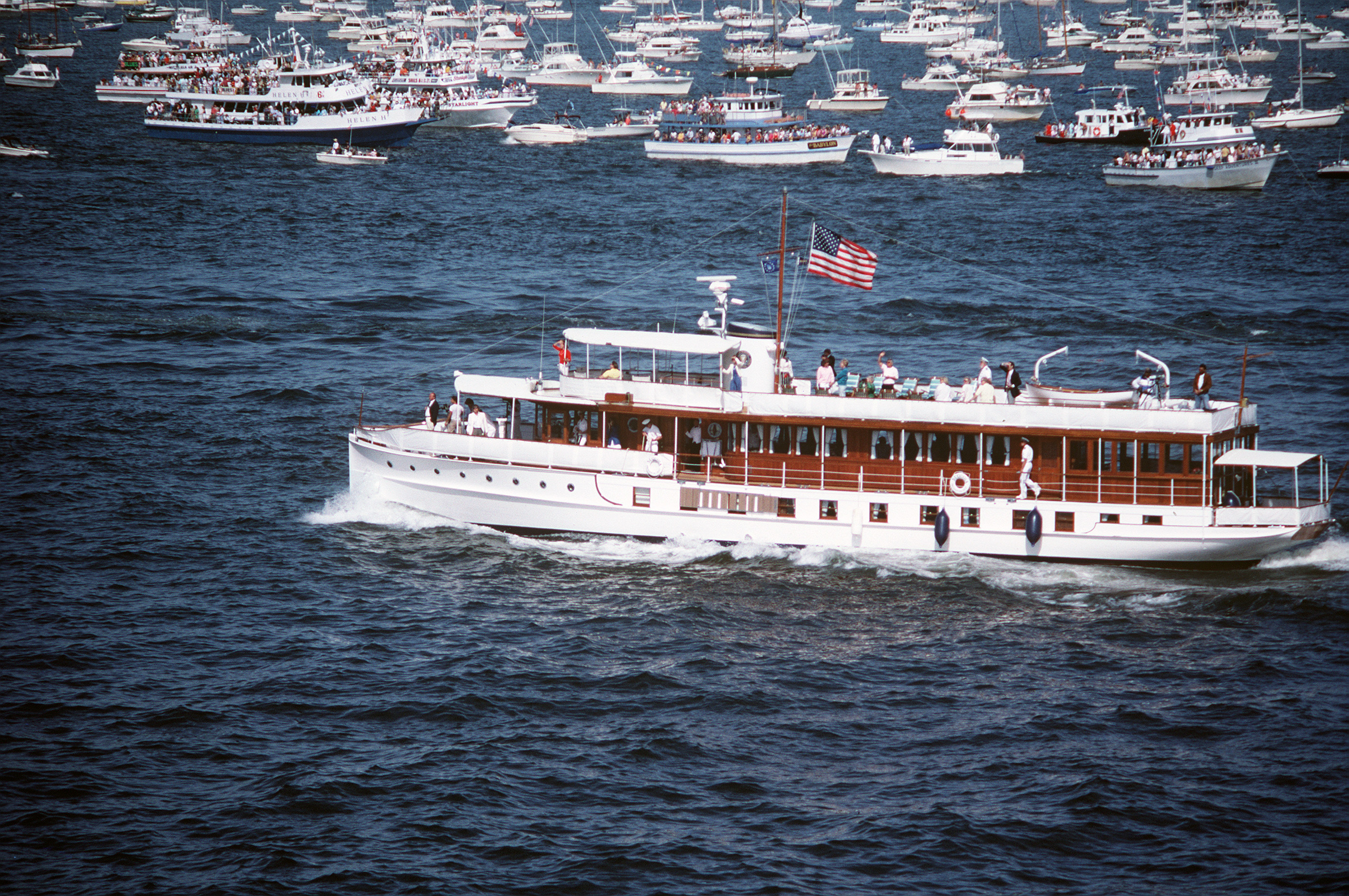 The Sequoia, the former presidential yacht, passes in review during the International Naval Review celebrating the centennial of the Statue of Liberty, New York Harbor, 4 July 1986. Photograph by PH1 R.E. Kerns.