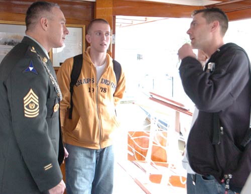 Sgt. Maj. William J. Gainey, Senior Enlisted Advisor to the Chairman of the Joint Chiefs of Staff, talks with wounded soldiers and their families aboard the USS Sequoia on the way to Mount Vernon, Virginia, 11 October 2005.