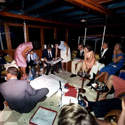 President John F. Kennedy opening gifts with family and friends aboard USS Sequoia on his 46th birthday, 29 May 1963.